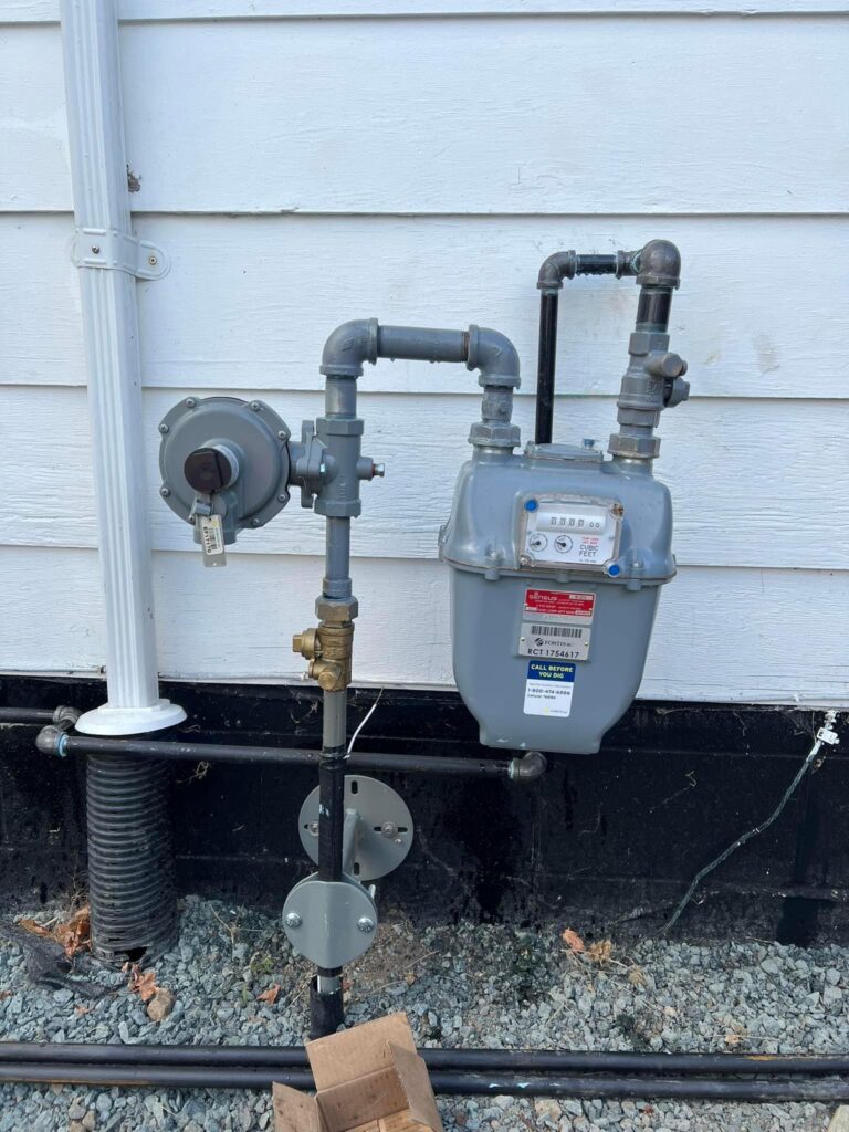 certified plumbers near me grey gas meter installed beside a white house outside